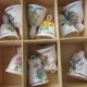 porcelanowy w miniaturze kolekcjonerski dzwonek  - JANUARY  CARNATIOS     - kwiaty miesiąca