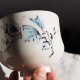Porcelanowa czarka do herbaty, ręcznie malowana, turkusowe motywy roślinne