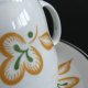 Porcelanowa filiżanka ze spodkiem, Włocławek, pomarańczowo-zielona dekoracja, PRL