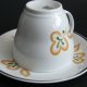 Porcelanowa filiżanka ze spodkiem, Włocławek, pomarańczowo-zielona dekoracja, PRL