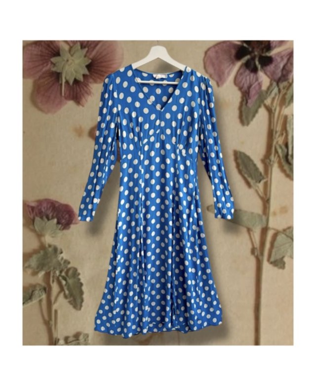 An amazing vintage boho dress with puff sleeves and classic white polka dots