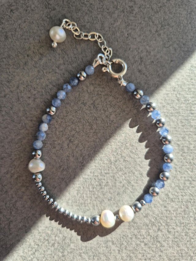 Srebrna bransoletka z niebieskich szafirów i białych pereł z zawieszką